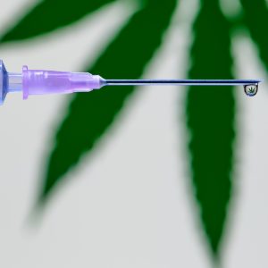 Vaccination Needle and Cannabis Leaf